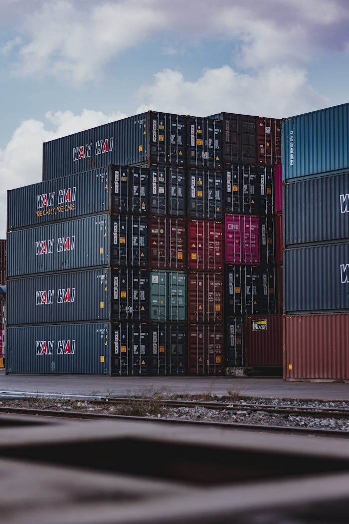 why-choose-us High vertical stack of cargo containers at a port, symbolizing global logistics.